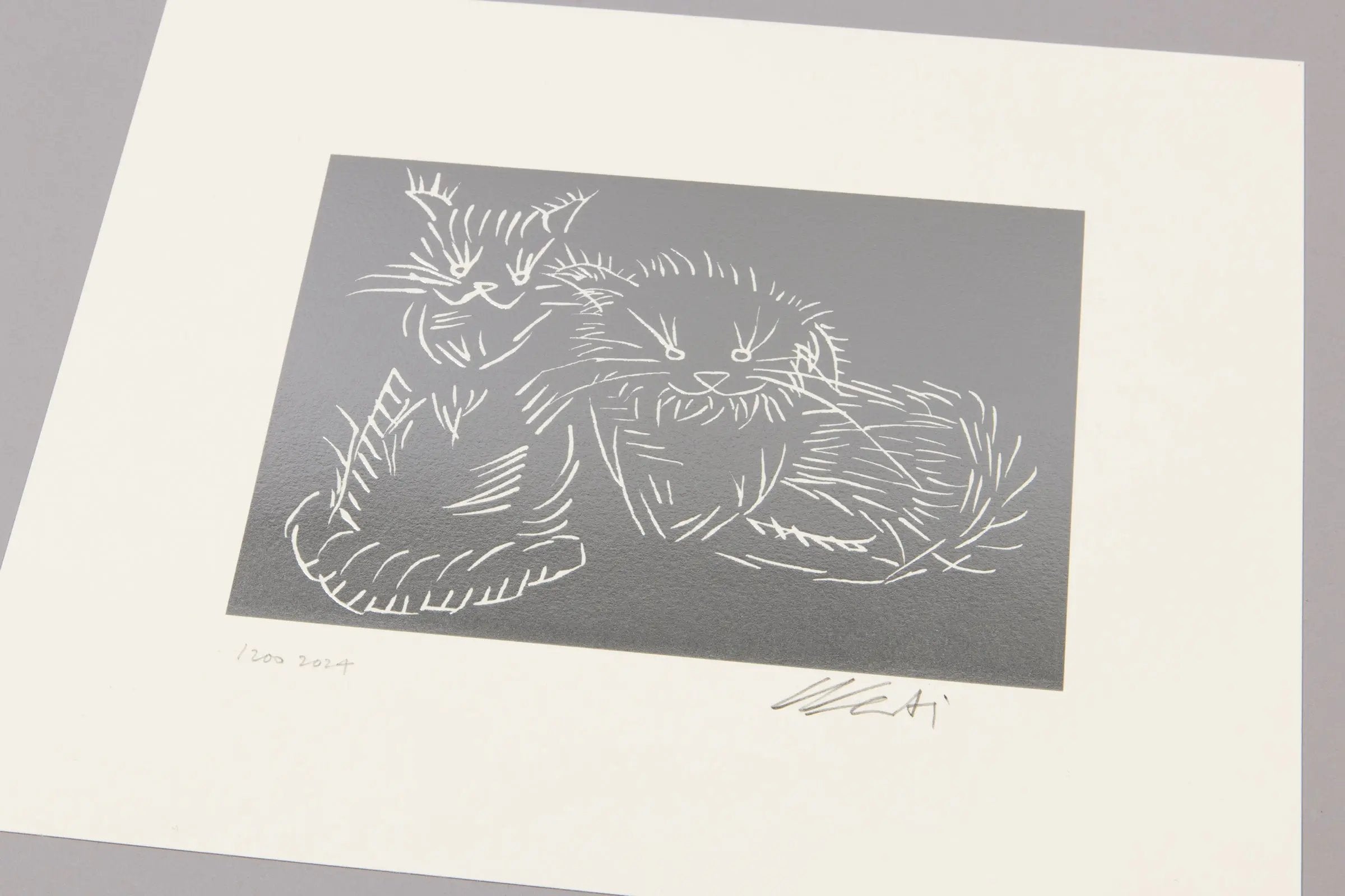 Ai Weiwei's depiction of a cat on a silver background with a signature at the bottom right corner.
